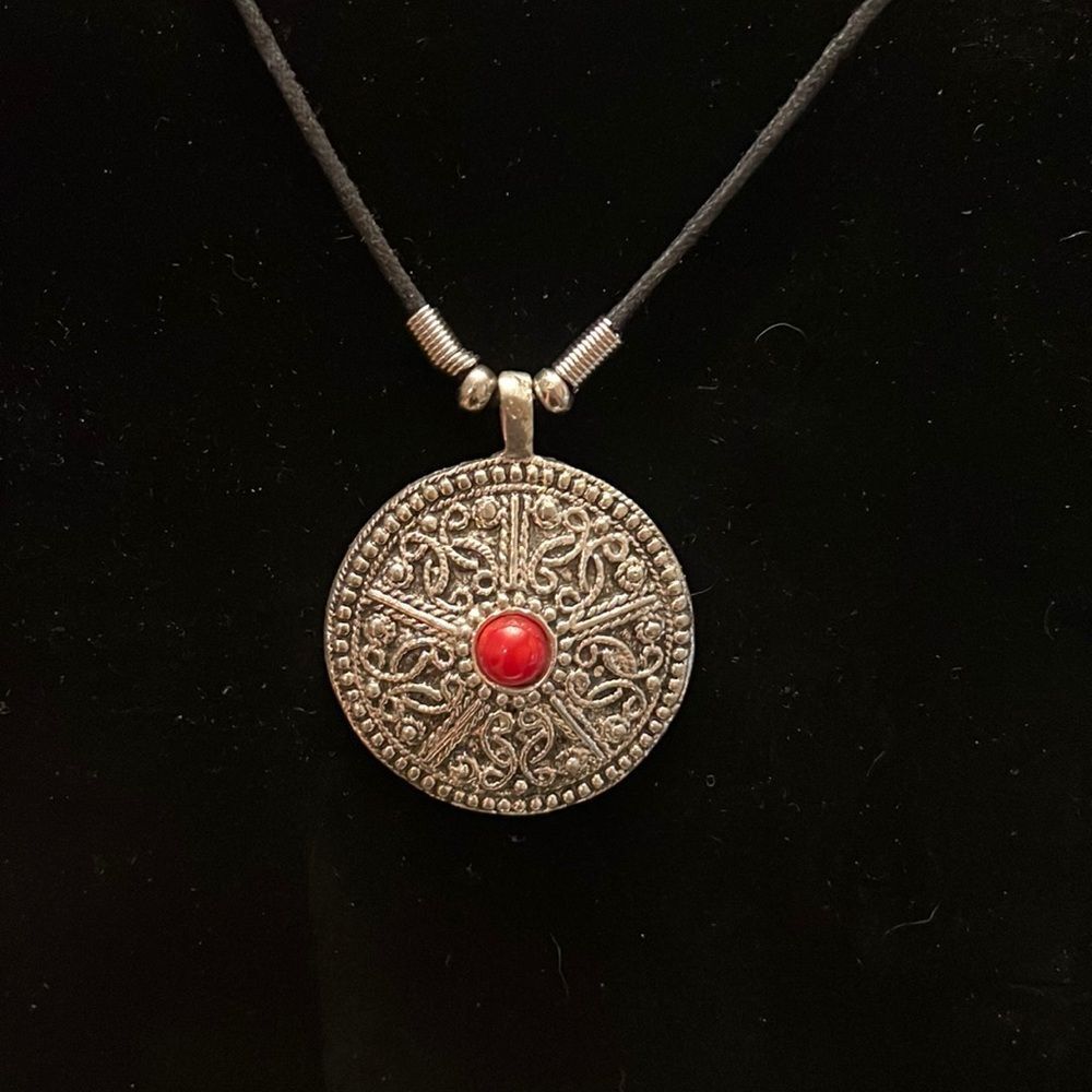Handcrafted round pendant with red center on an 18 inch cord necklace